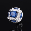 Exquisite silver ring with large square blue gemstone and white pear-cut accents on black background - Blue
