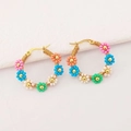 Handmade colorful beaded flower hoop earrings in gold with vibrant summer vibe - Rainbow