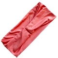 Close-up of coral milk silk yoga headband with cross-knot design and breathable fabric - Peach