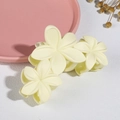 Detailed close-up of cream yellow matte flower hair claw clip on a white textured background - 11CM Matte Milk White 02 (Three Flowers)
