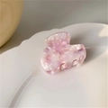 Pink marble acetate heart hair claw clip shown on a white ceramic wave plate - Pink Marble Pattern