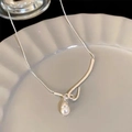 Detail of silver drop necklace with freshwater pearl on a textured ceramic surface - 925 Silver / Silver (5.3g)