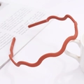 Detail of matte wavy headband in Morandi orange with non-slip tooth design - Horizontal Wave / Brick Red