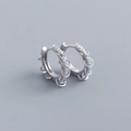 Macro detail of S925 sterling silver hoop earrings with pavé zircons and dangling rings - White Gold