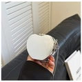 Detail of silver heart-shaped mini mirror bag with chain strap held by hand - Heart / Silver