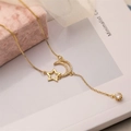 Gold-plated necklace with hollow star and zircon moon pendant on jewelry box - Star Moon Tassel Necklace