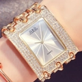 Close-up of gold square quartz watch with triple chain strap and sparkling rhinestones - White Dial Gold Strap With Diamonds