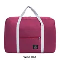 Foldable travel bag in wine red durable nylon with grey handles and front zipper pocket - Burgundy