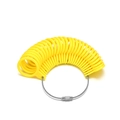 Macro shot of yellow plastic ring sizer measuring loops on a durable steel cable wire - Measuring Gauges / Yellow