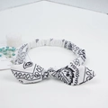 Elastic white paisley bunny ear headband with black floral print and bow tie detail - White Paisley