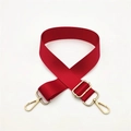 Detail of red nylon shoulder strap with adjustable golden metal buckle and lobster clasps - Red