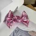 Close-up of pink metallic leather bow hair clip on a minimalist denim background - Rose Pink