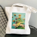 White canvas tote bag featuring a colorful floral print on a black metal chair - Colorful Flowers on Blue-green Background