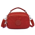 Chic red nylon crossbody bag for women with adjustable strap and top handle design - Bengala Red