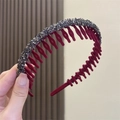 Detail of burgundy non-slip headband with sparkling grey crystal rhinestones held in hand - Red
