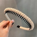 Detail of beige textured fabric headband with black anti-slip inner toothed comb structure - Off White