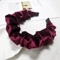Close-up of pleated velvet headband in wine red with premium ribbon wrapped ends - Burgundy