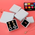Minimalist white jewelry gift box set with black foam inserts on a pink background - Light Blue
