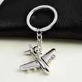 Close-up of a silver metal fighter jet keychain with a polished finish and a link chain - Single Engine Propeller Plane (飞机1)