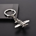 Macro shot of silver propeller aircraft keychain with polished metal finish on dark surface - Classic Civil Airliner (飞机12)