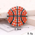 Macro shot of an orange rhinestone basketball charm measuring 2.8cm and 8.8g in weight - Basketball