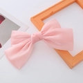 Macro detail of a pink pearlescent satin bow hair clip with double-layer pleated texture - Pink Pearl Luster Bow Spring Clip