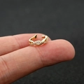 Macro shot of gold-plated non-pierced ear cuff with sparkling zircon cross-twisted design - 5# / Gold