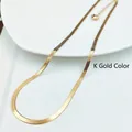 Detailed macro view of K-gold flat snake chain necklace with small heart pendant - Heart Pendant Snake Chain (2019526) / Gold