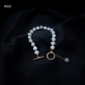 Macro detail of natural Baroque pearl bracelet with golden OT clasp on black satin - Vintage Baroque Pearl Style (B-222)