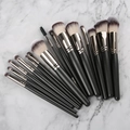 Set of 12 black makeup brushes with dual-tone bristles on a white marble background - 15Pcs Black