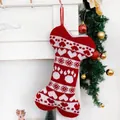 Macro shot of red and white knitted bone-shaped pet Christmas stocking on fireplace - Bone Shape-Heart Paw / Knitted Bone Stocking Red