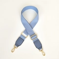 Close-up of sky blue canvas strap with golden metal hooks and leather ends for bags - Light Blue / Silver