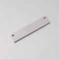 Macro detail of silver rectangle stainless steel connector plate with two holes - Steel