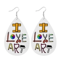 Detail of teardrop leather earrings featuring 'I LOVE ART' text and artistic tool patterns - I Love Art Theme