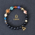 Detail of Libra zodiac bracelet with matte black beads, colorful stones and gold charms - Libra
