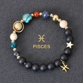 Detailed view of beaded solar system bracelet with Pisces zodiac charm and golden planets - Pisces