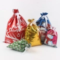 Set of colorful Christmas gift bags with festive patterns and ribbon ties on white - Set 4 (20-Piece)