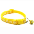Detail of yellow nylon pet collar featuring white paw prints, buckle, and golden bell - JY Paw Print / Yellow