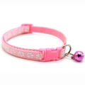 Detailed view of pink nylon pet collar with white paw prints, buckle and silver bell - JY Paw Print / Pink