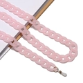 Macro shot of pink matte acrylic eyeglass chain with gold metal rings and silicone loops - Pink