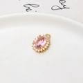 Detail showing an oval pink crystal pendant with sparkling micro-paved cubic zirconia - Oval Pink / 11*15mm