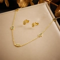 Golden Hamsa hand jewelry set with necklace and stud earrings on an elegant display - Necklace Earrings 2-Piece Set (N2740)