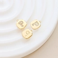 Macro detail of gold-plated square letter P pendant with sparkling zircon inlay - Letter P