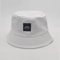 Detailed view of white cotton bucket hat with black embroidered smiley face patch - M (56-58cm) / White (Smile Face Patch)