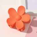 Close-up of matte orange flower hair claw clip with detailed five-petal plastic design - Matte Flower Hair Clip - Orange Red