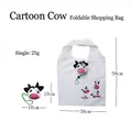 Foldable waterproof cow print shopping bag shown in open and compact cow head shape - Cow