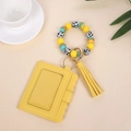 Detail of yellow wave-edge PU card holder with silicone bead wristlet and tassel - Yellow