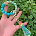 Close-up of printed silicone bead keychain bracelet with colorful tassel and gold ring - Colorful Tassel Blue Marble Beaded (款10)