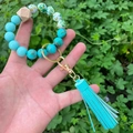 Detail of beaded wristlet keychain featuring marble patterns, wood beads, and blue tassel - Blue Tassel Green Gold Marble Beaded (款16)