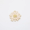 Detailed macro view of pink enamel daisy flower pendant charm with gold alloy edges - White